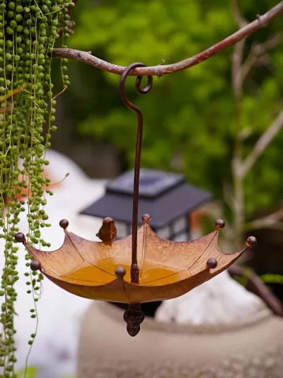 An antique umbrella shaped metal bird food tray, outdoor hanging bird bathtub and food bowl, decorative garden yard accessories